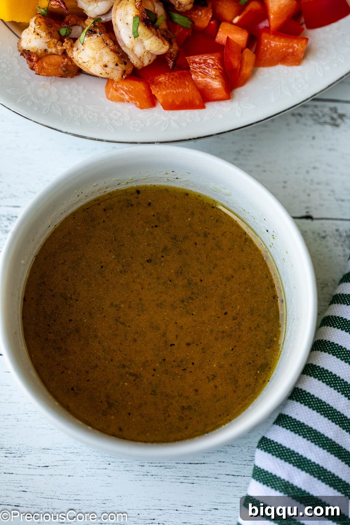 A small white bowl filled with the homemade Honey Lime dressing, perfectly emulsified and ready to be drizzled.