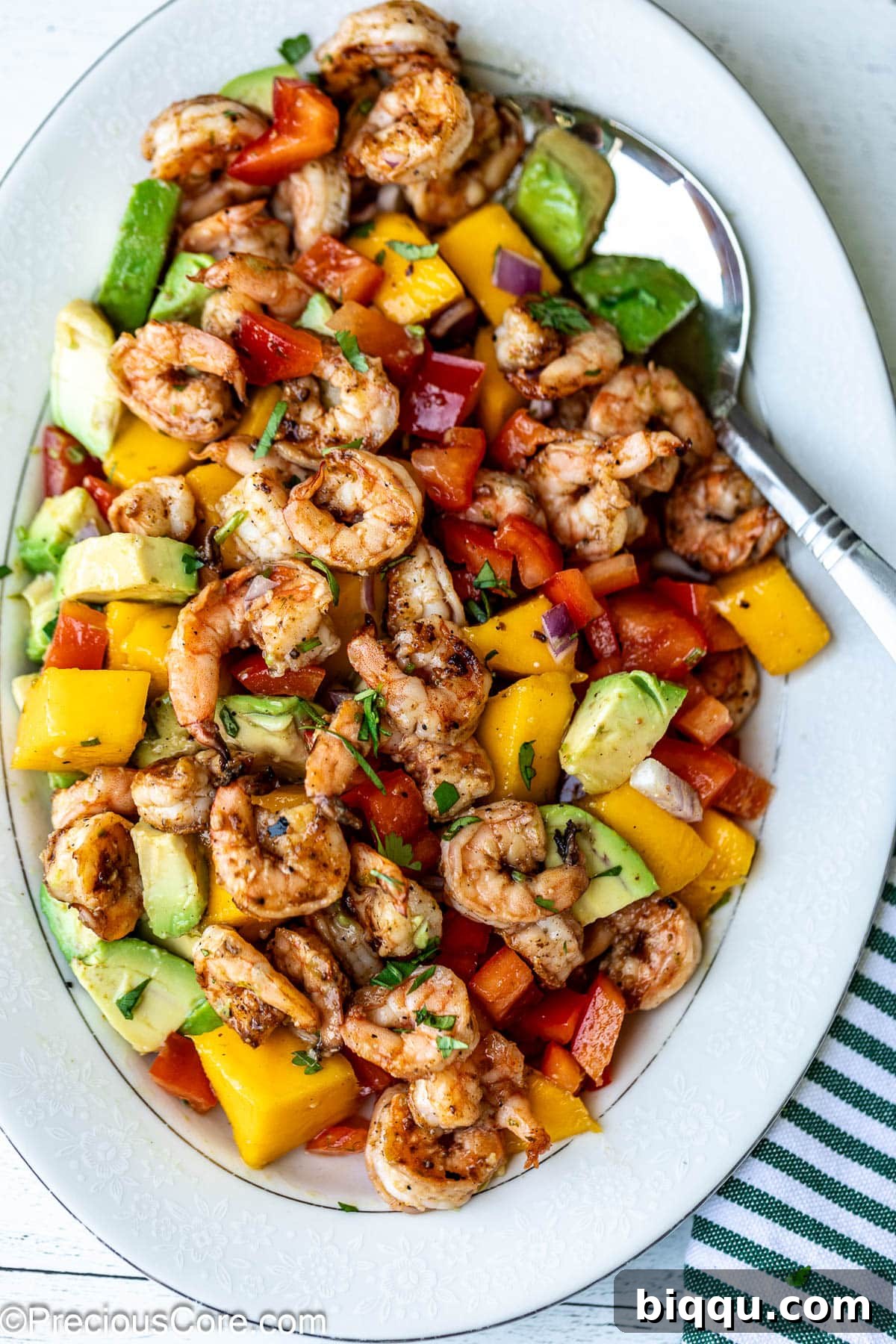A vibrant, tossed Mango Shrimp Salad in a serving bowl, showcasing the colorful mix of ingredients.