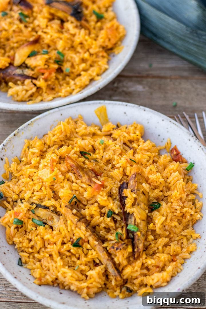 Bowls of perfectly cooked palm oil jollof rice, ready to be served and enjoyed.