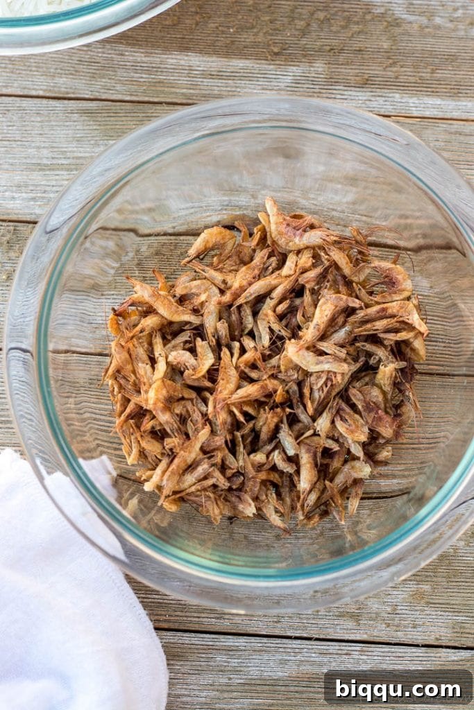 A bowl filled with dried crayfish, a key ingredient for Njanga Rice, highlighting its unique texture.