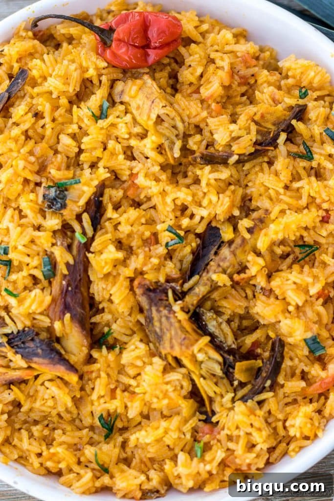 A hearty bowl of native jollof rice, showcasing its rich color and inviting texture, ready to be enjoyed.