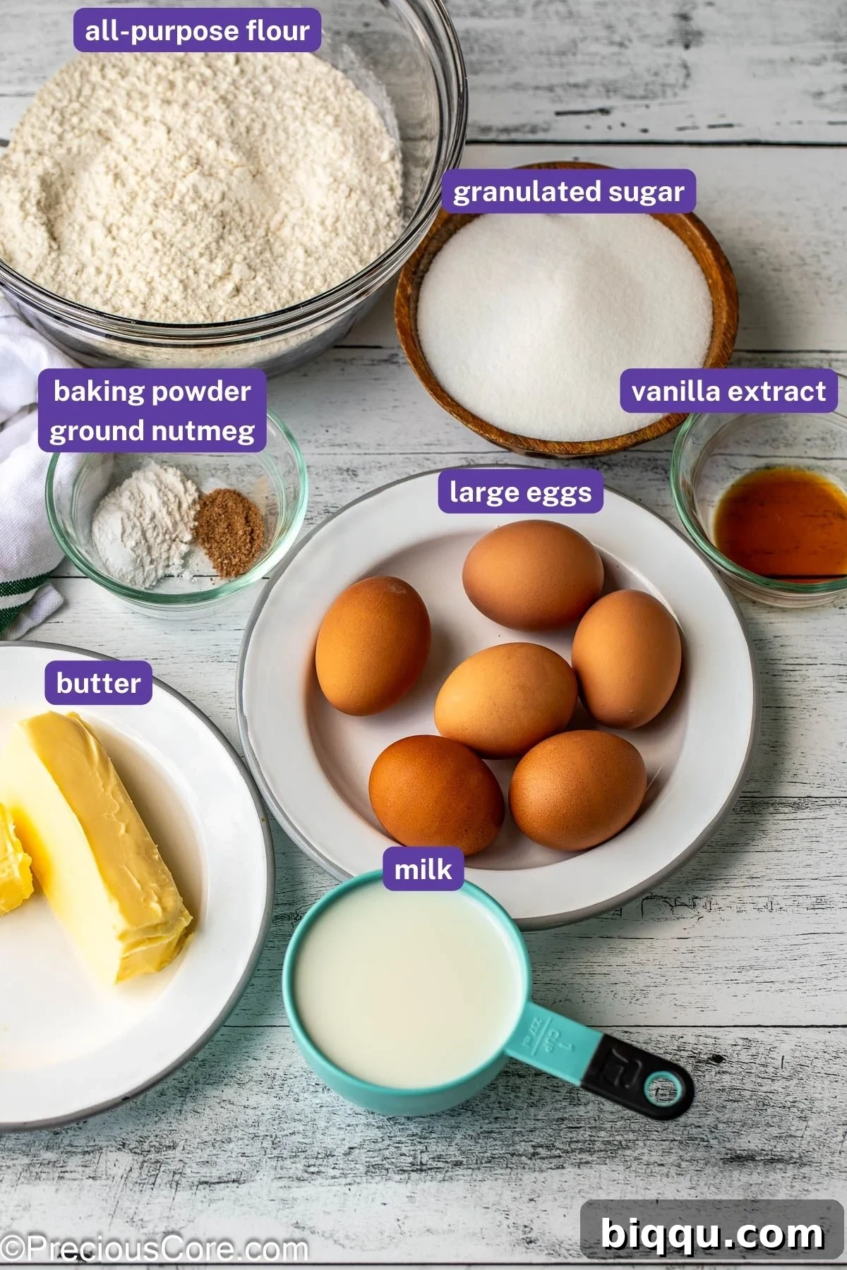 All ingredients for the plain cake recipe laid out on a kitchen counter with labels.