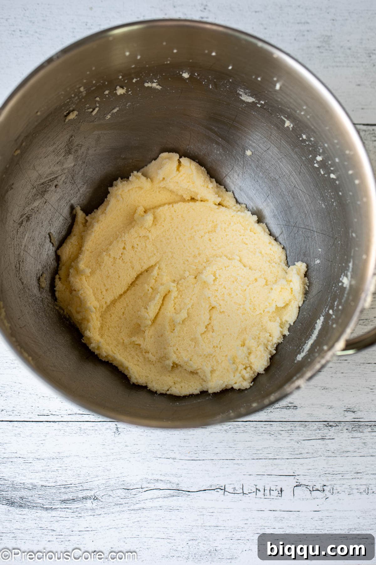 A bowl containing perfectly creamed butter and sugar, light and fluffy.