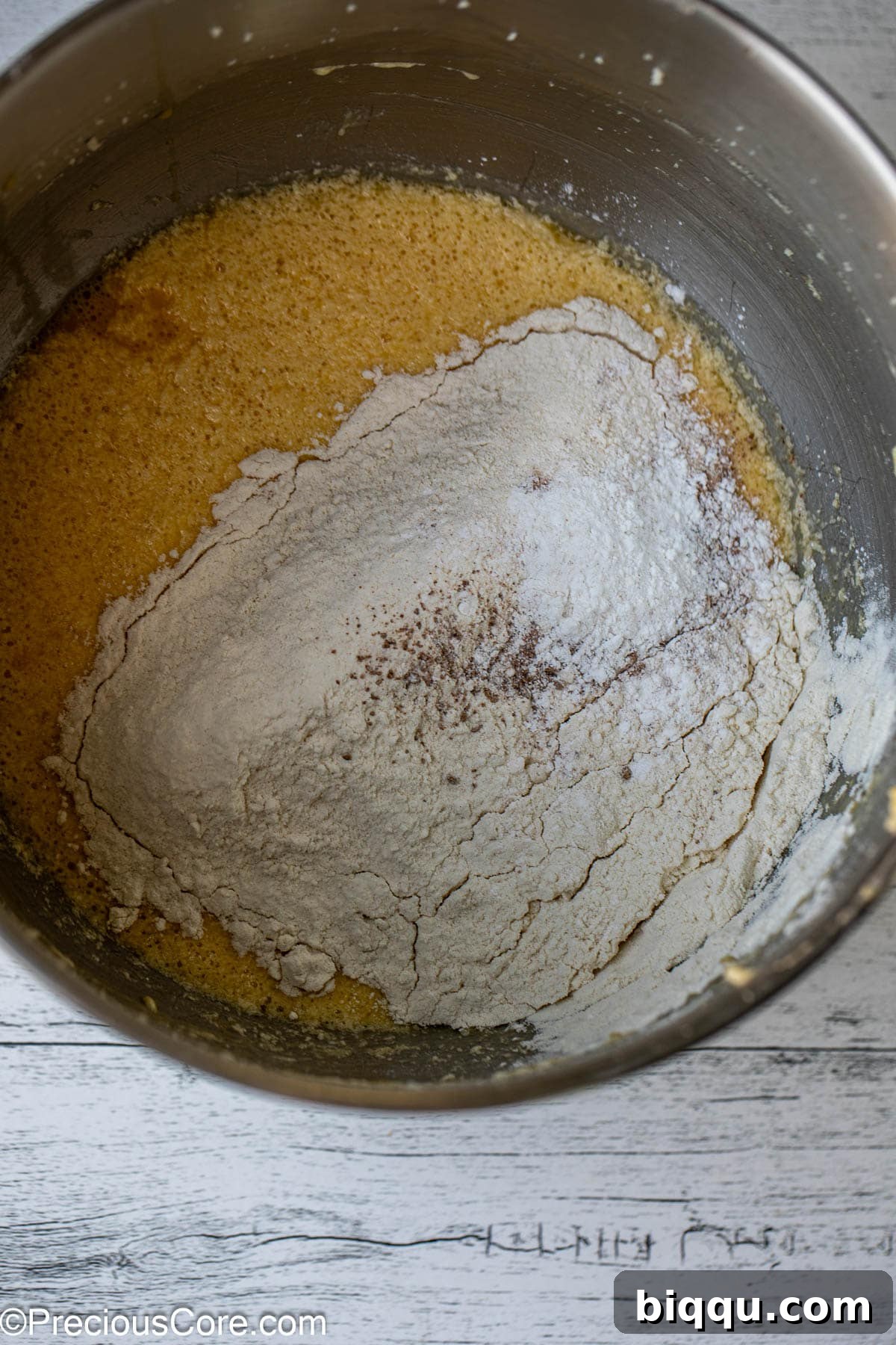 Dry ingredients (flour, nutmeg, baking powder) blended into the cake batter.