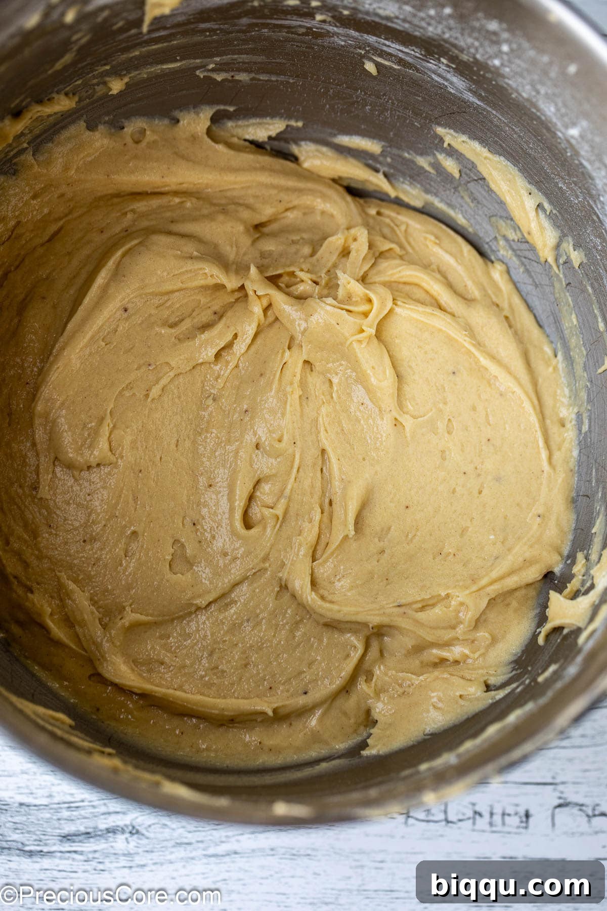 Smooth, well-mixed cake batter in a metal mixing bowl.