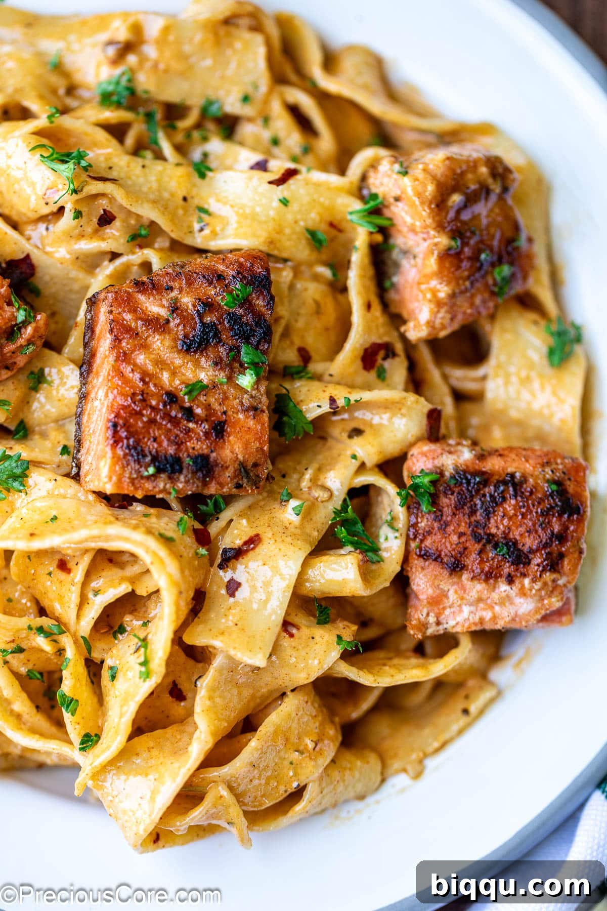 Cajun Pasta with Salmon with fresh parsley garnish.