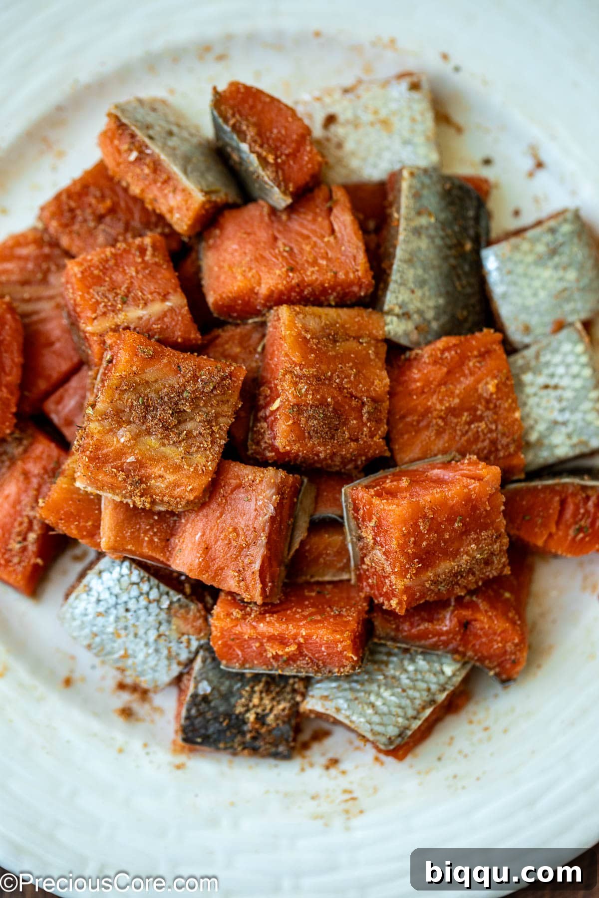 Raw salmon seasoned with Cajun spices, garlic powder, and salt.