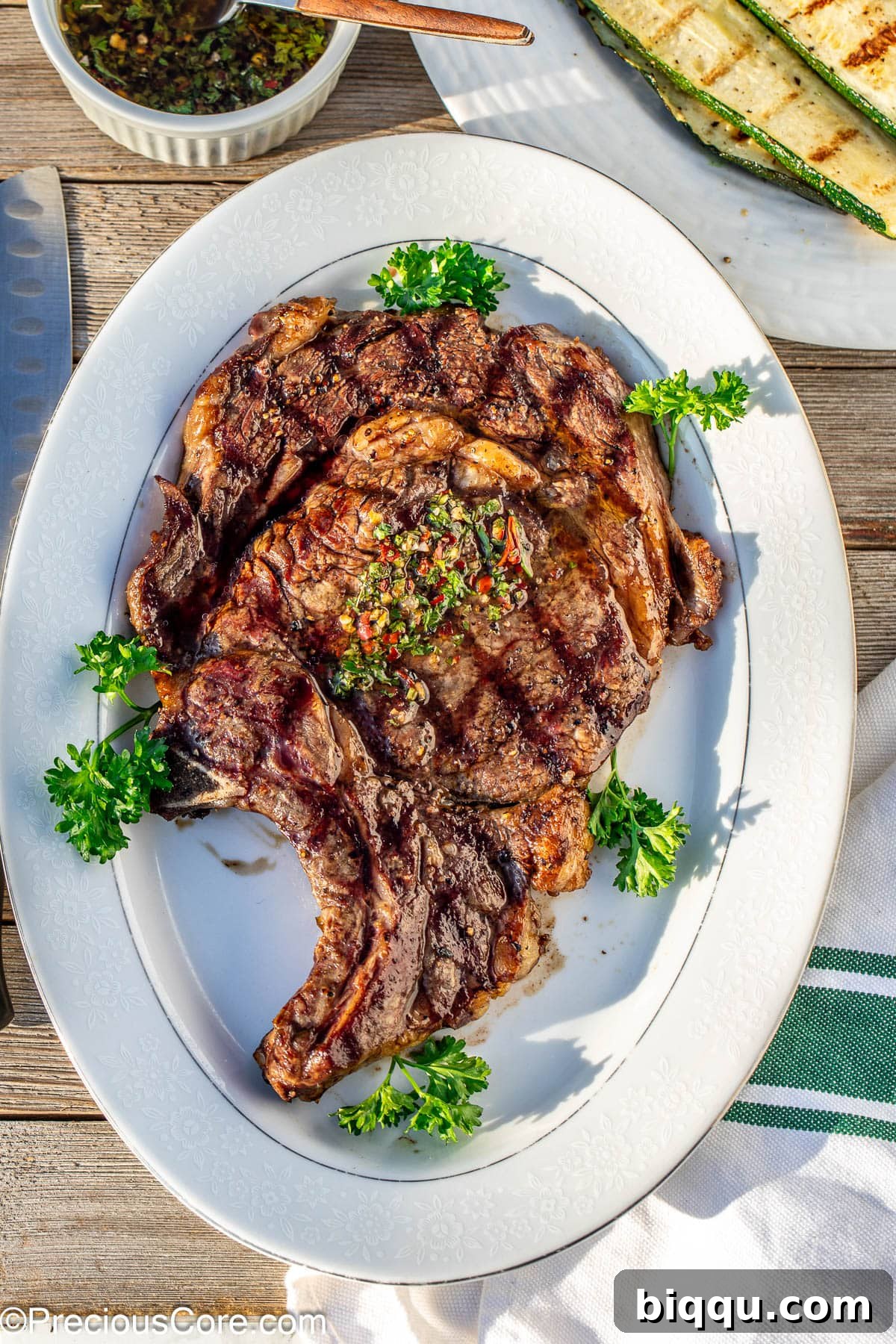 Bone in ribeye served on a white tray.