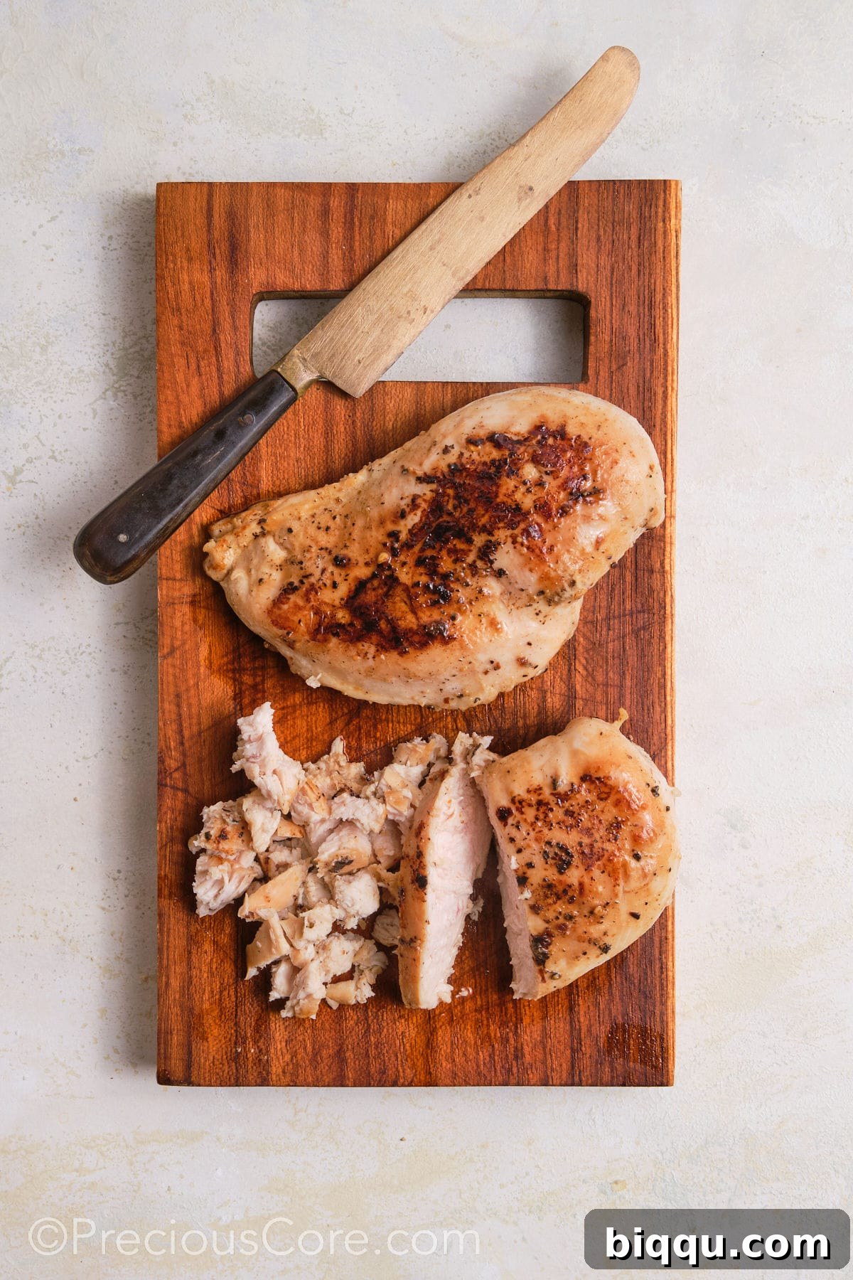 Dicing chicken breasts into small pieces.