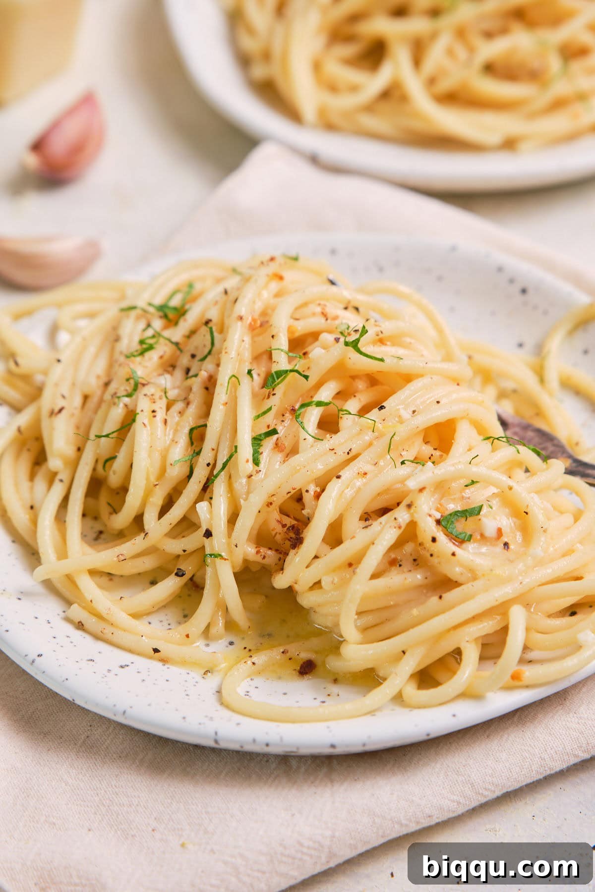 Zesty Lemon Garlic Butter Pasta 2 Lemon Garlic Butter Pasta on a speckled plate, garnished with fresh parsley.