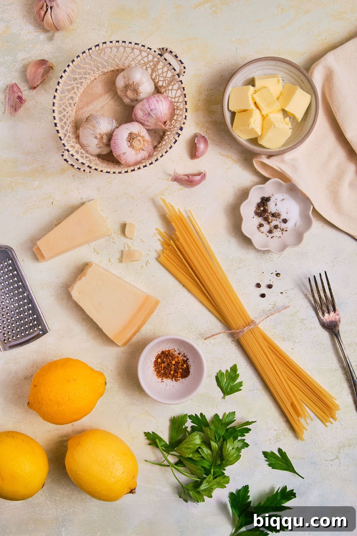 Zesty Lemon Garlic Butter Pasta 6 Arrangement of ingredients for Lemon Garlic Butter Pasta, including spaghetti, lemons, garlic, butter, and cheese.