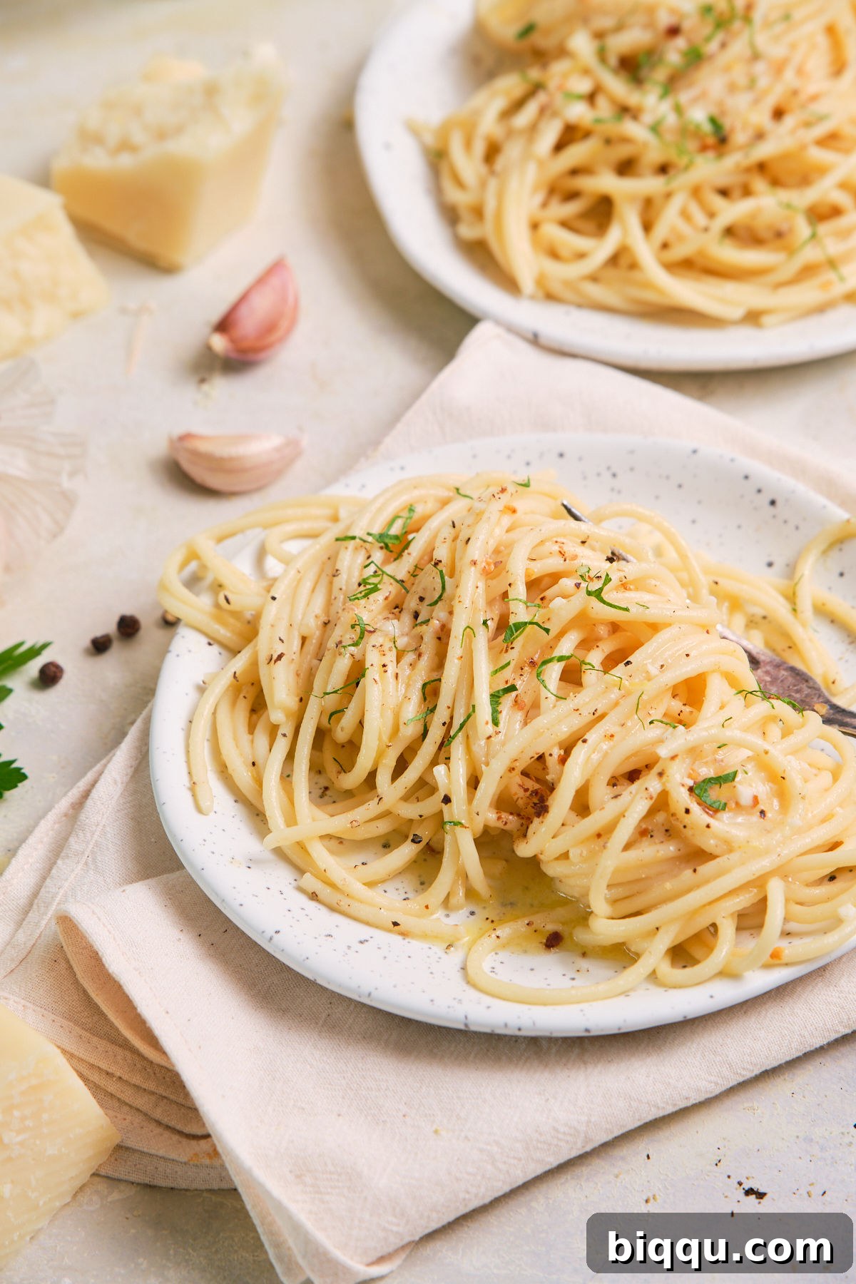 Zesty Lemon Garlic Butter Pasta 7 Close-up of a plate of spaghetti perfectly cooked with garlic and butter sauce, garnished.