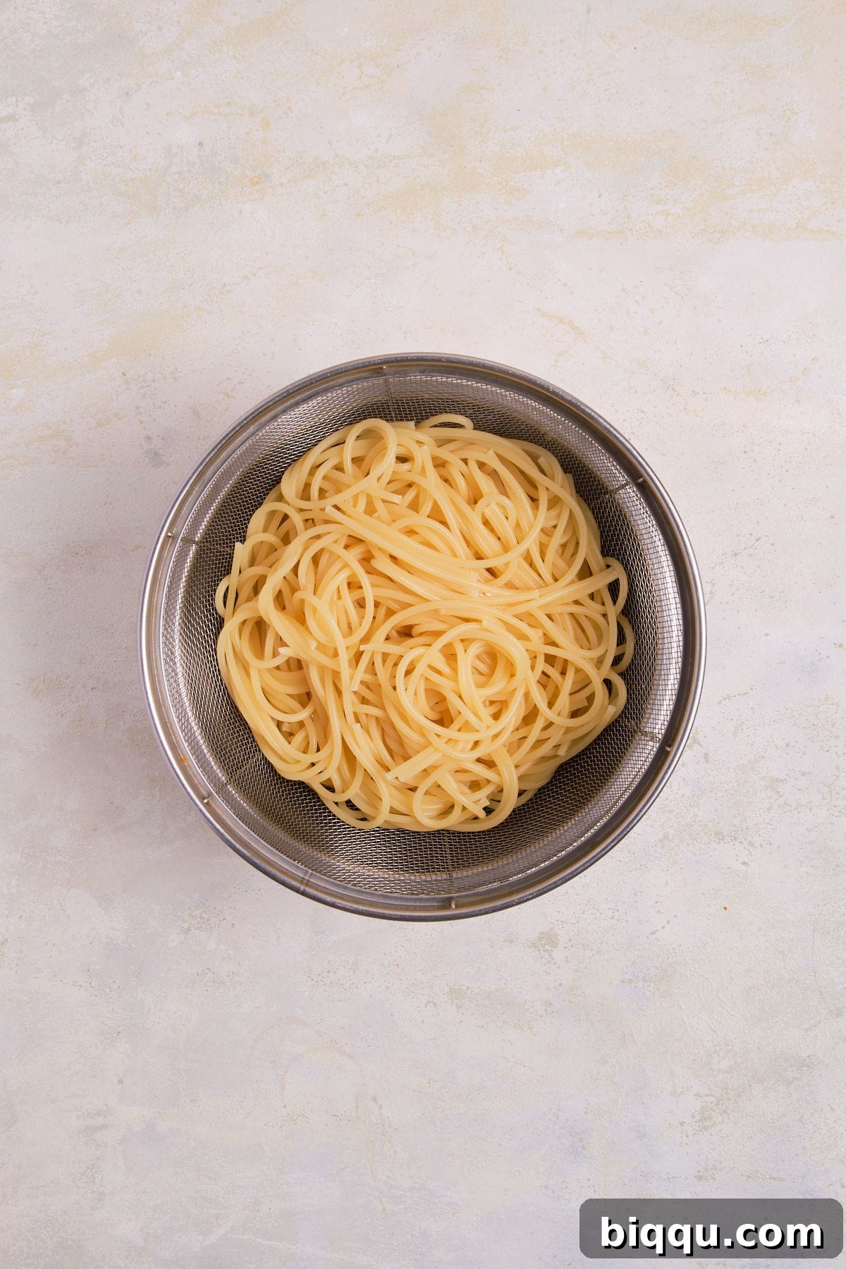 Zesty Lemon Garlic Butter Pasta 10 Drained pasta resting in a colander.