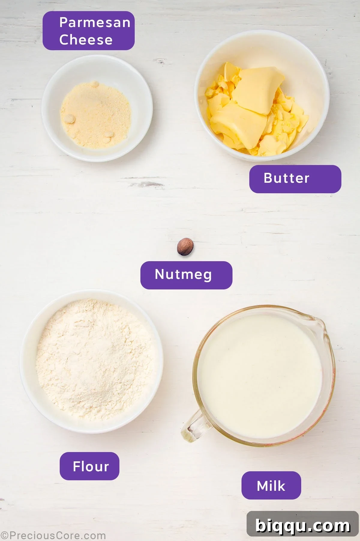 Arrangement of béchamel sauce ingredients: butter, flour, whole milk, nutmeg, and Parmesan cheese.