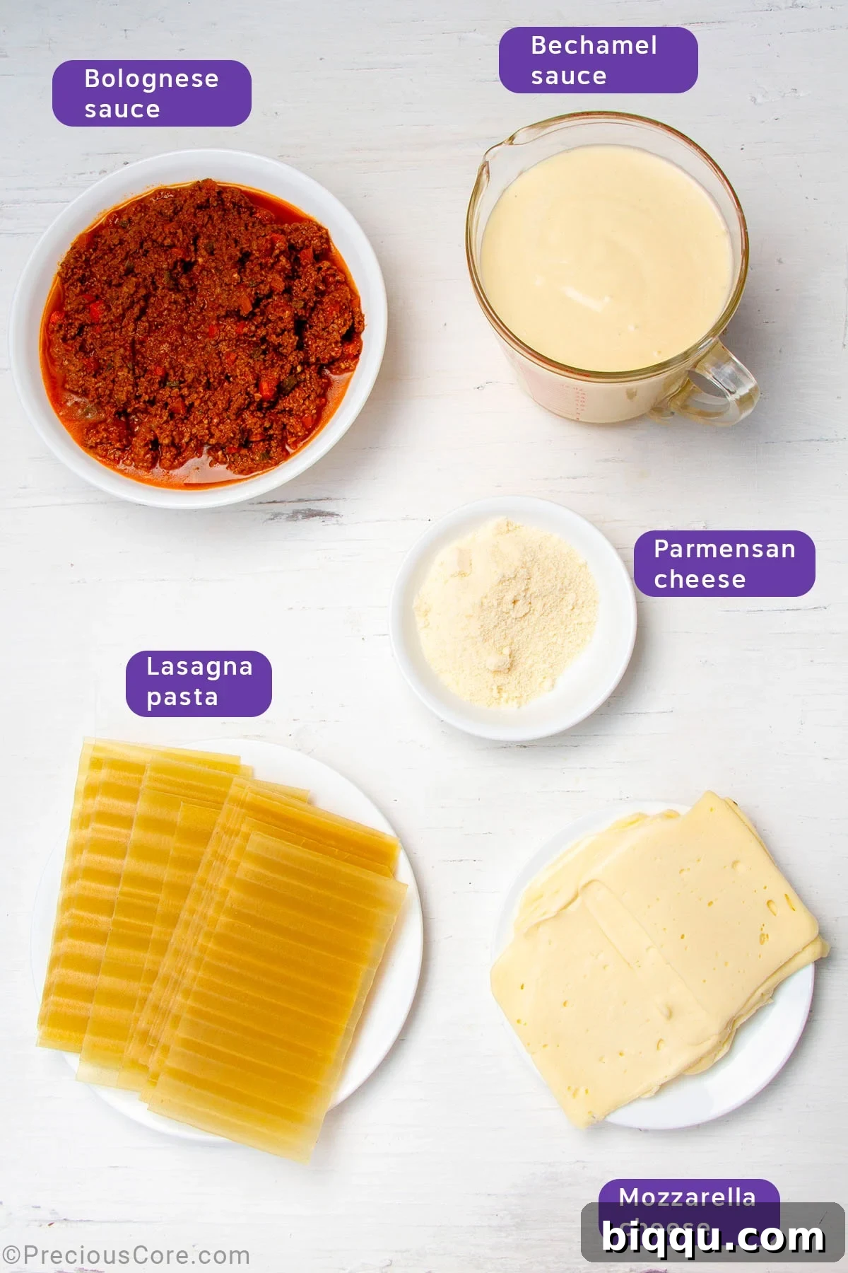 Full set of ingredients for assembling lasagna: béchamel, Bolognese, lasagna noodles, and shredded cheeses.