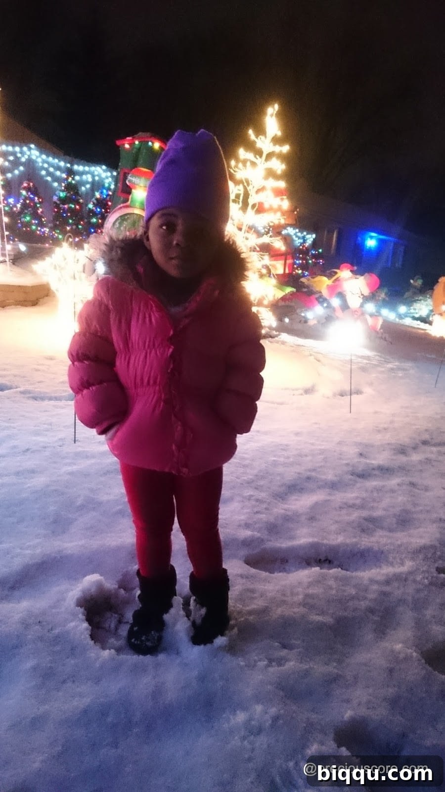 Family enjoying the festive atmosphere, taking pictures with holiday lights
