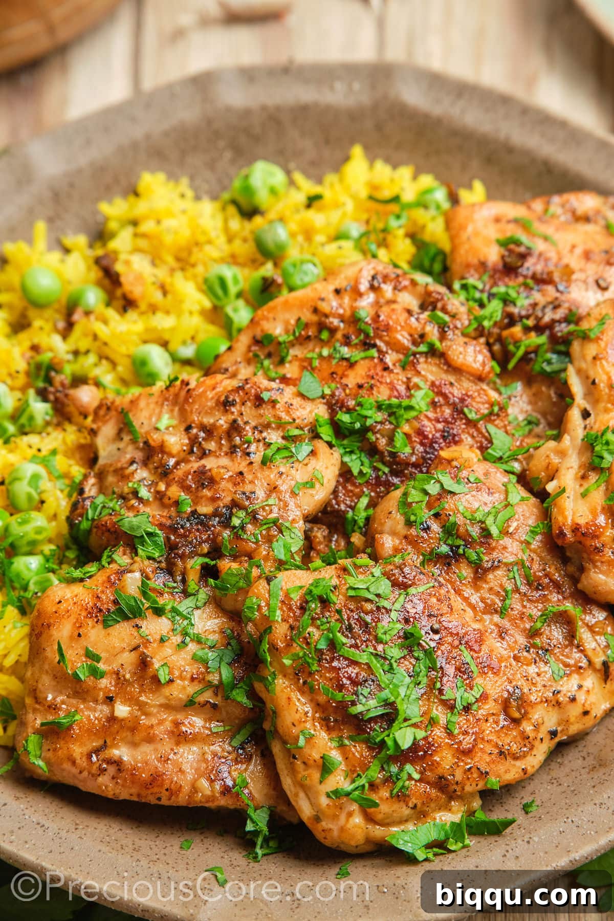 A close-up view of perfectly pan-seared boneless chicken thighs, showcasing their crispy skin and juicy texture.