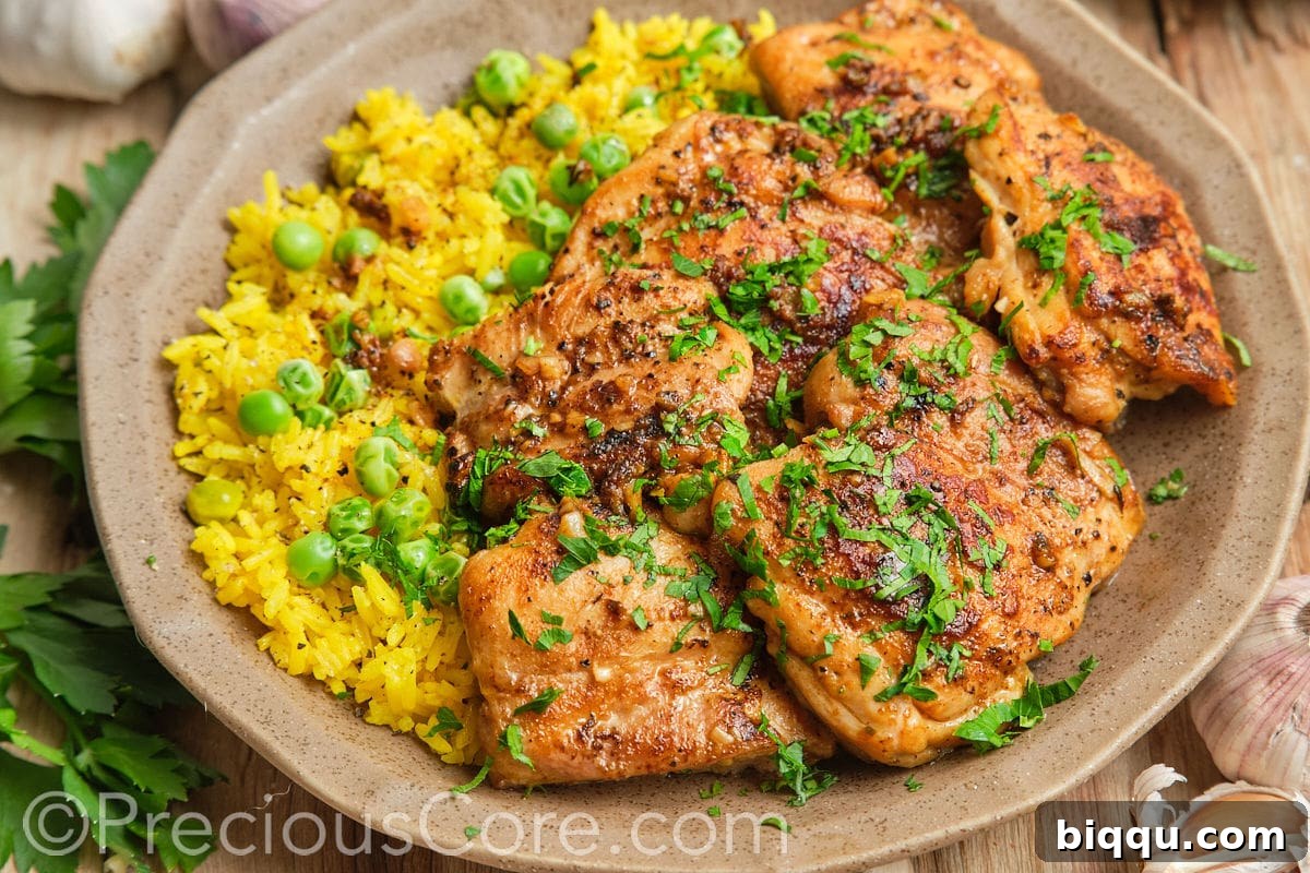 Landscape image showing a close-up of beautifully pan-seared boneless chicken thighs.