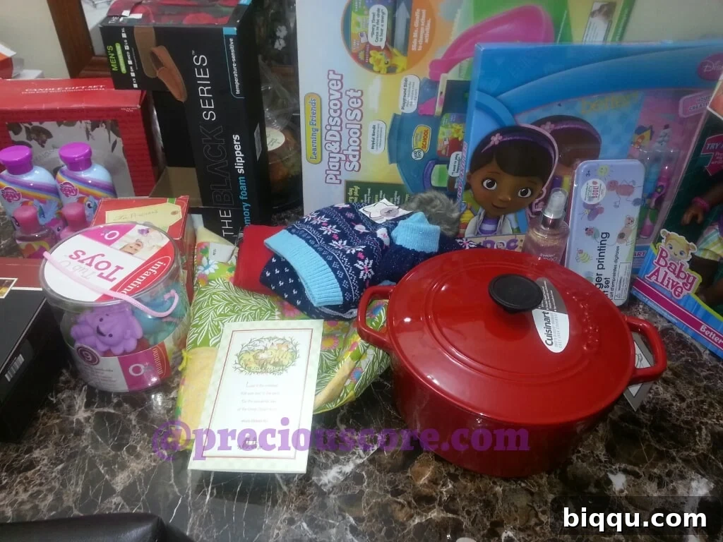 A collection of opened gifts, showing various household items and children's toys.