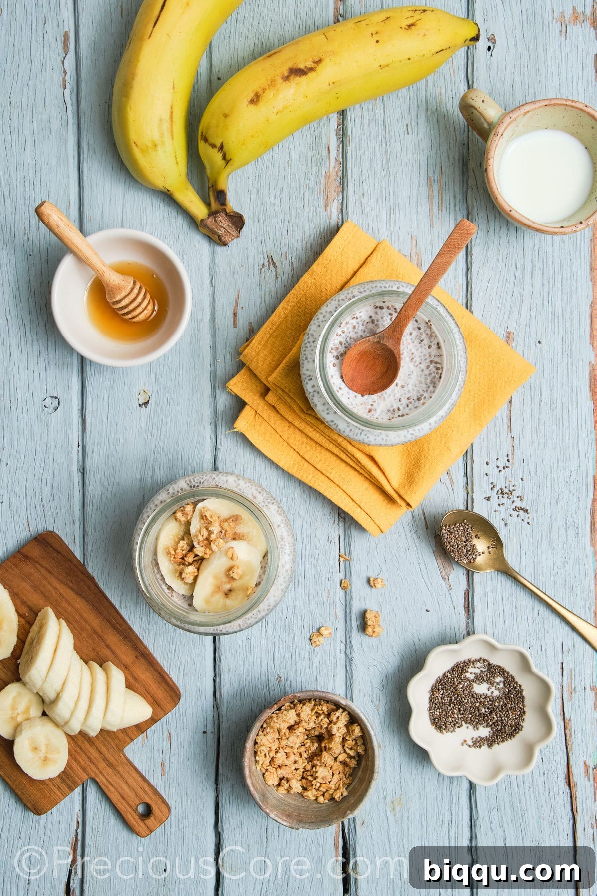 Banana chia seed pudding topped with fresh banana slices and chopped walnuts in a glass jar.