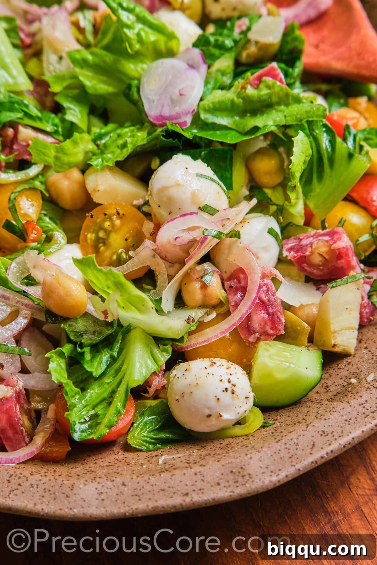 A detailed close-up shot of the Italian chopped salad, highlighting its diverse ingredients and textures.