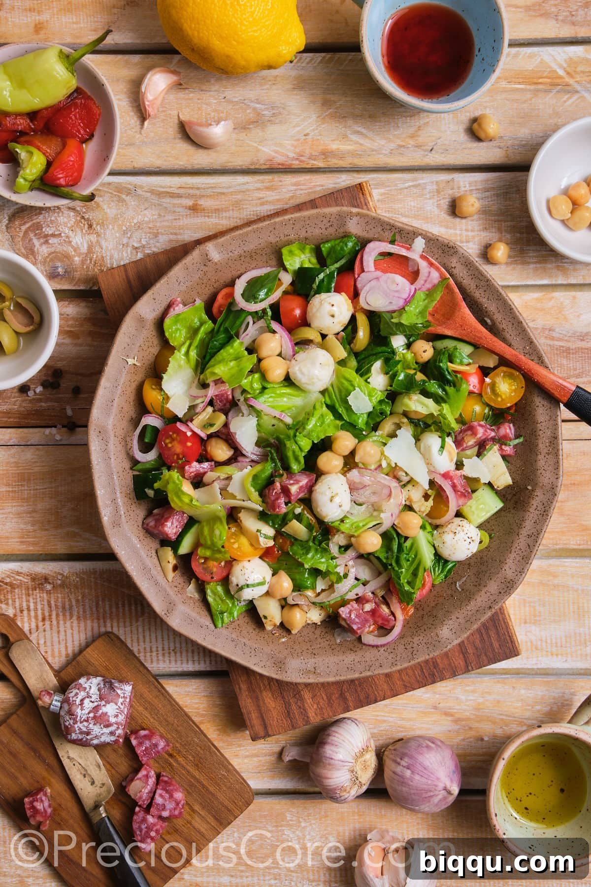 A vibrant chopped salad gracefully presented in a deep brown bowl.