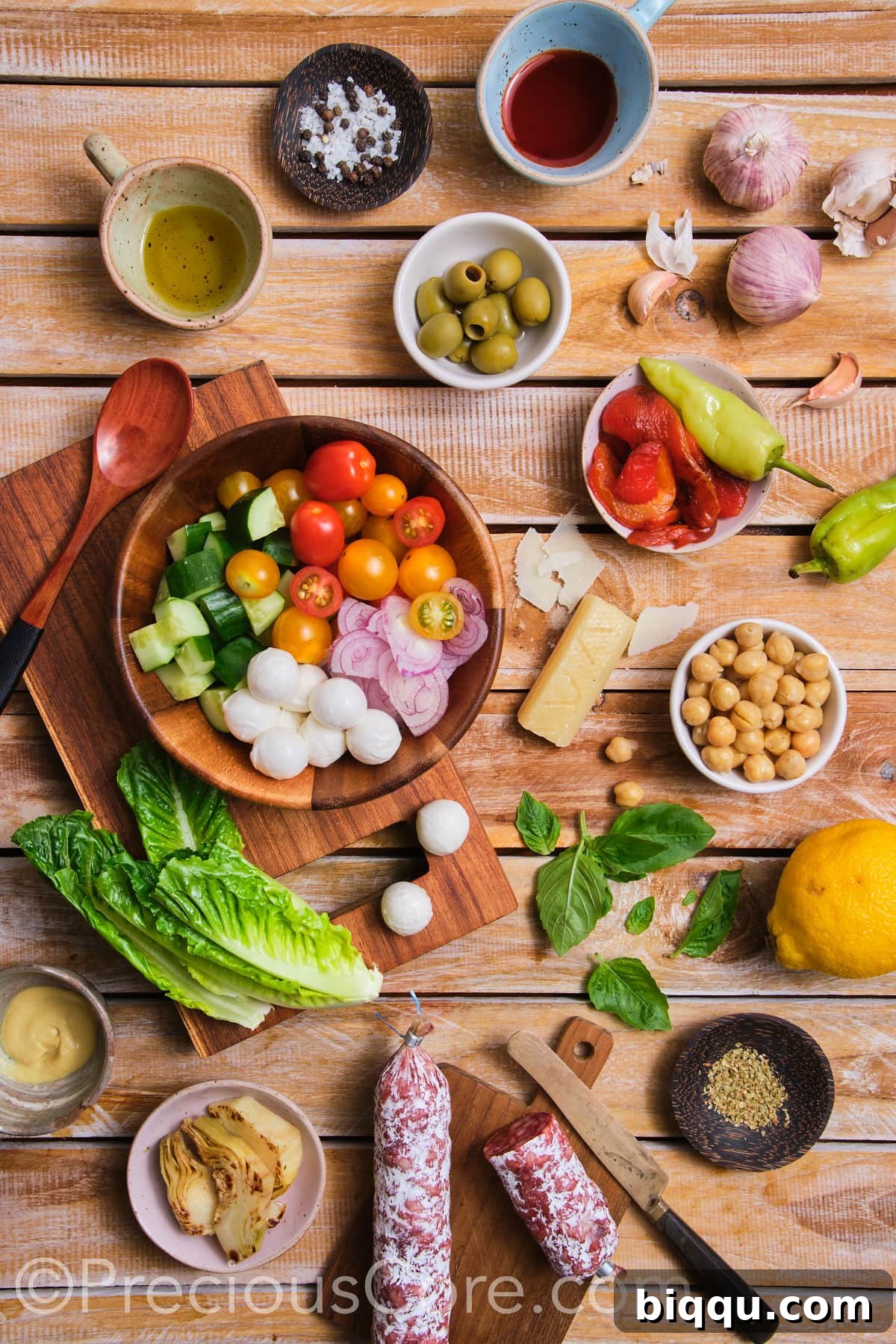 An array of fresh, colorful ingredients laid out, ready for an Italian Chopped Salad.
