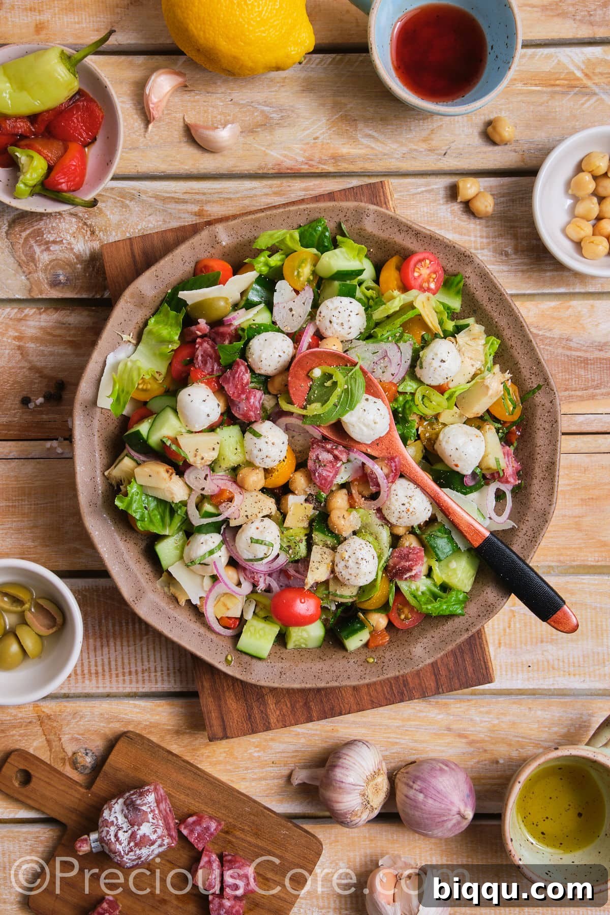 A large, rustic bowl overflowing with a vibrant, freshly prepared chopped salad.