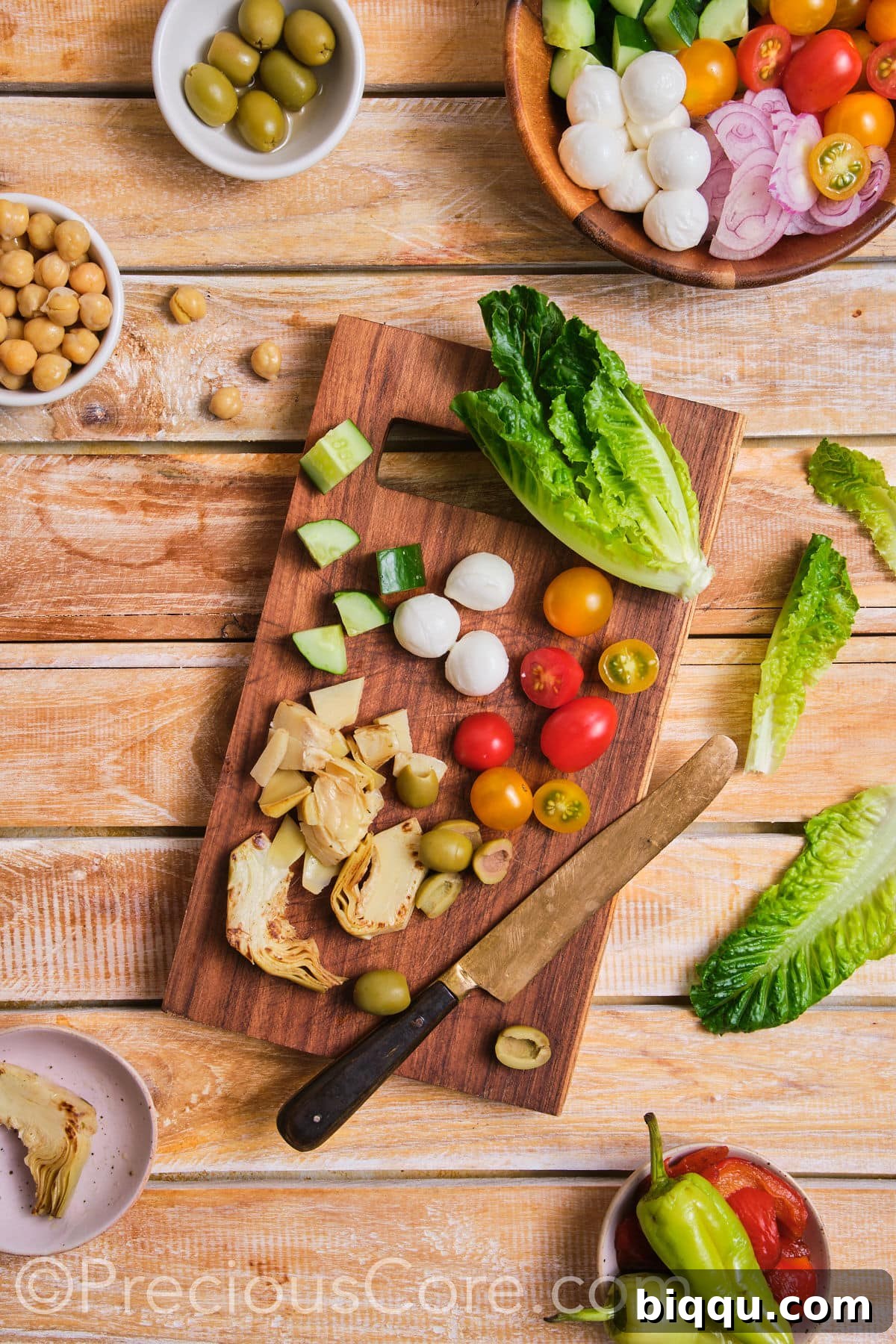 Fresh vegetables being expertly chopped on a clean cutting board for the salad.