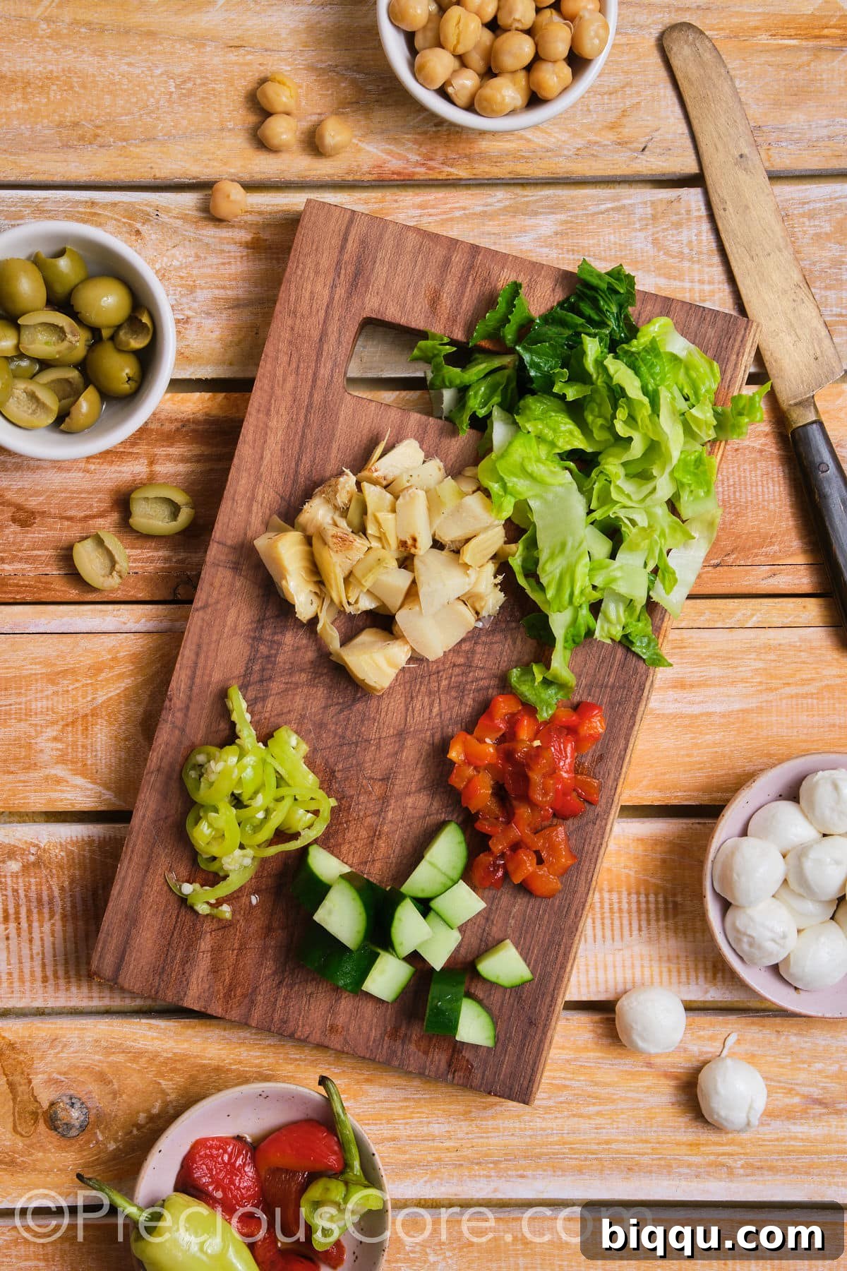 A collection of perfectly diced vegetables arranged neatly on a chopping board.