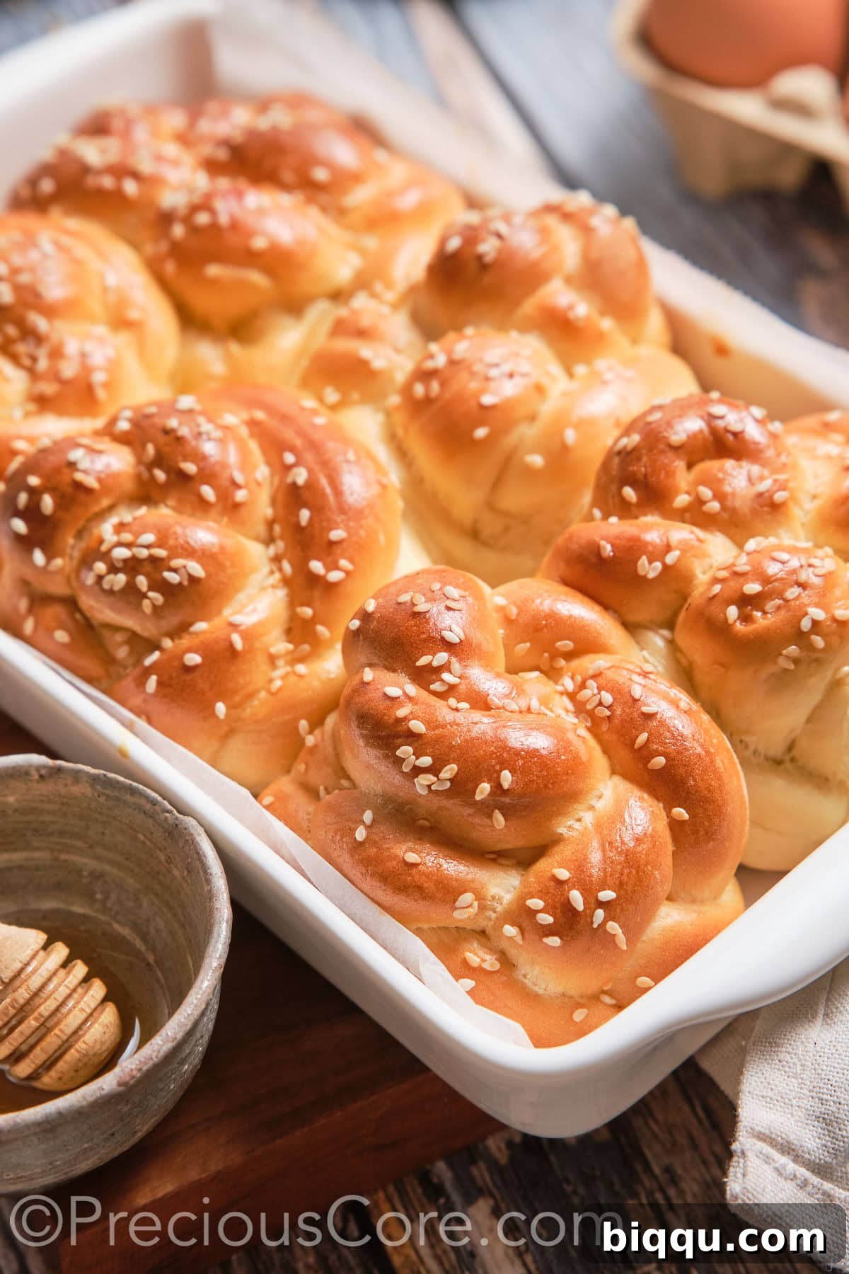 A baking dish of baked Challah Dinner Rolls, golden brown and perfectly puffed.