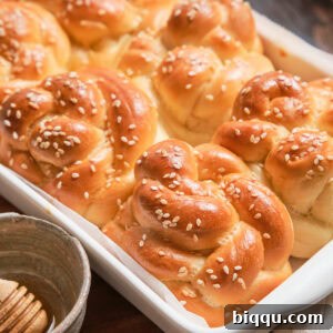 A baking dish of baked Challah Dinner Rolls.