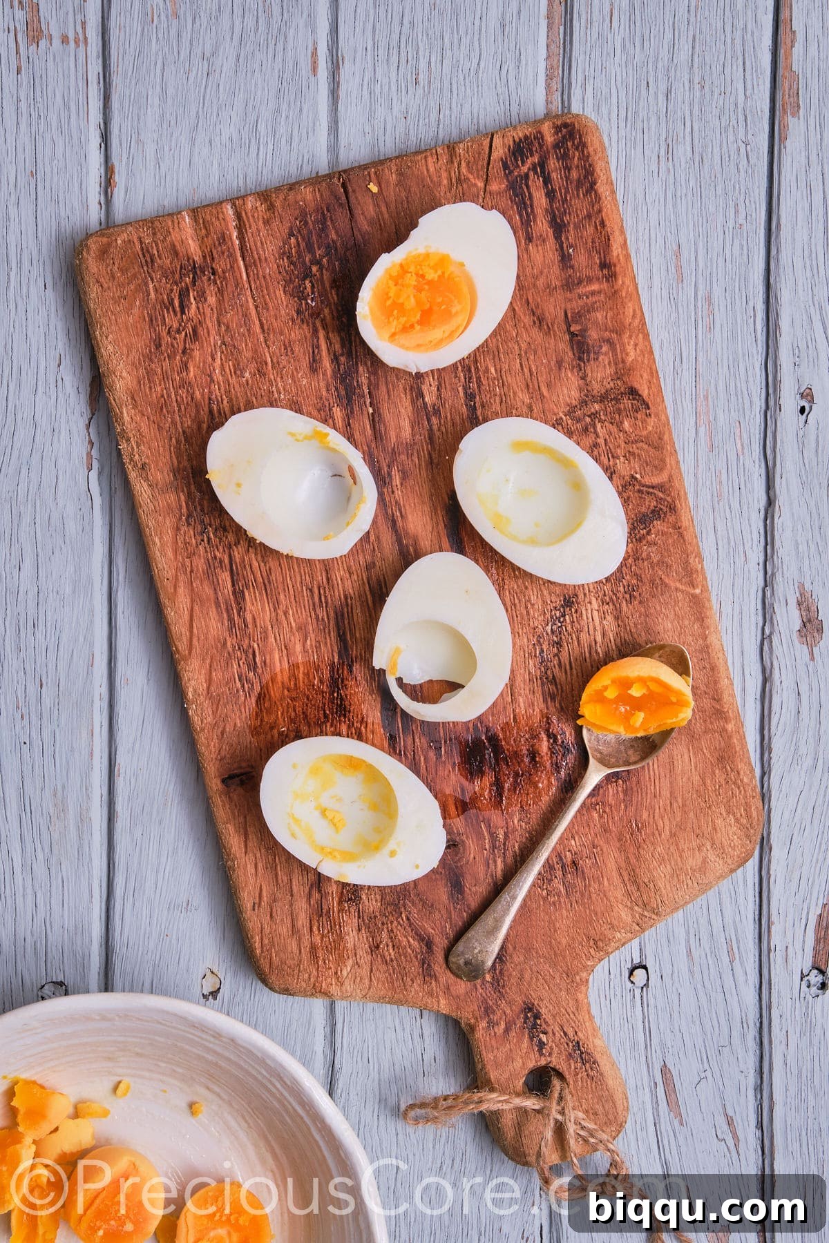 Bright yellow egg yolks neatly scooped out of their whites and collected in a small bowl.