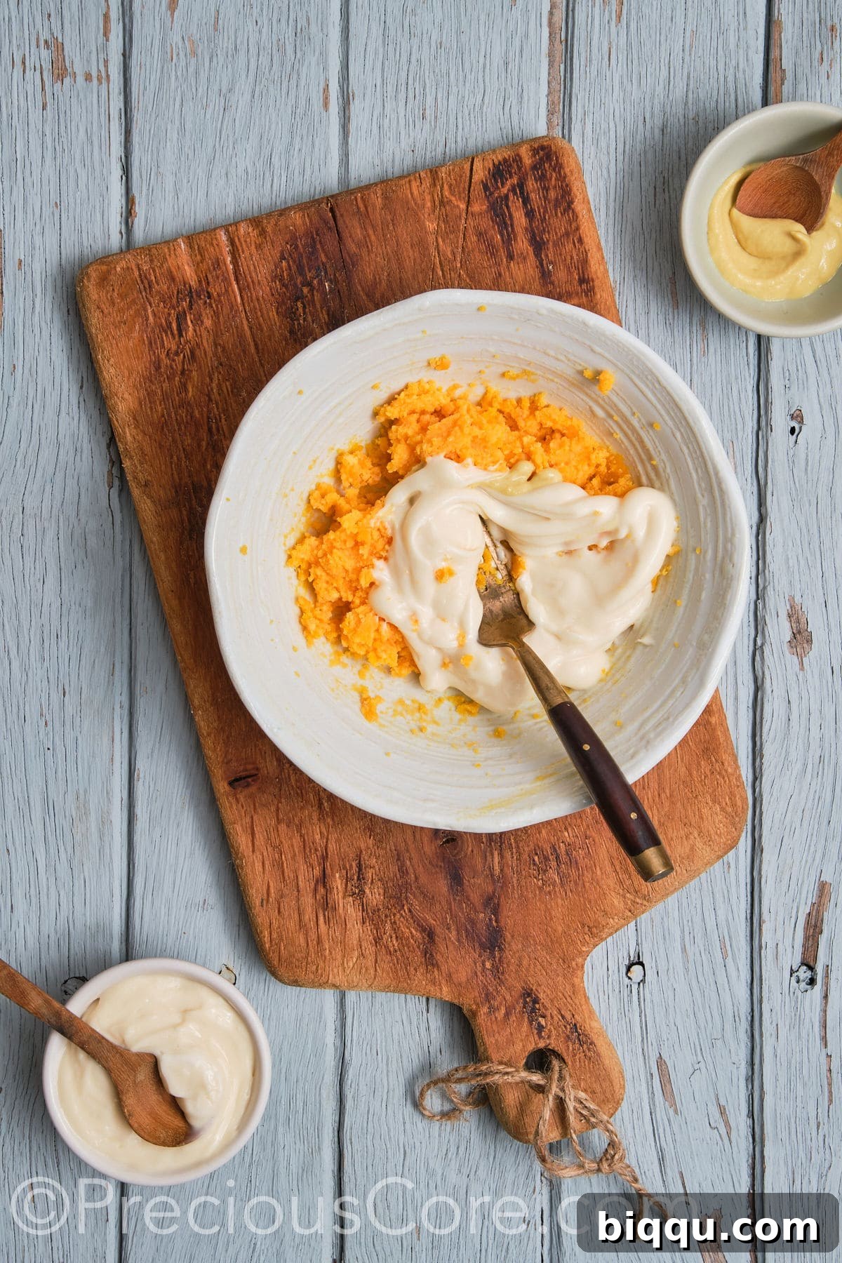 All the creamy ingredients for the deviled egg filling, including mashed yolks, mayonnaise, mustard, and spices, combined in a bowl.
