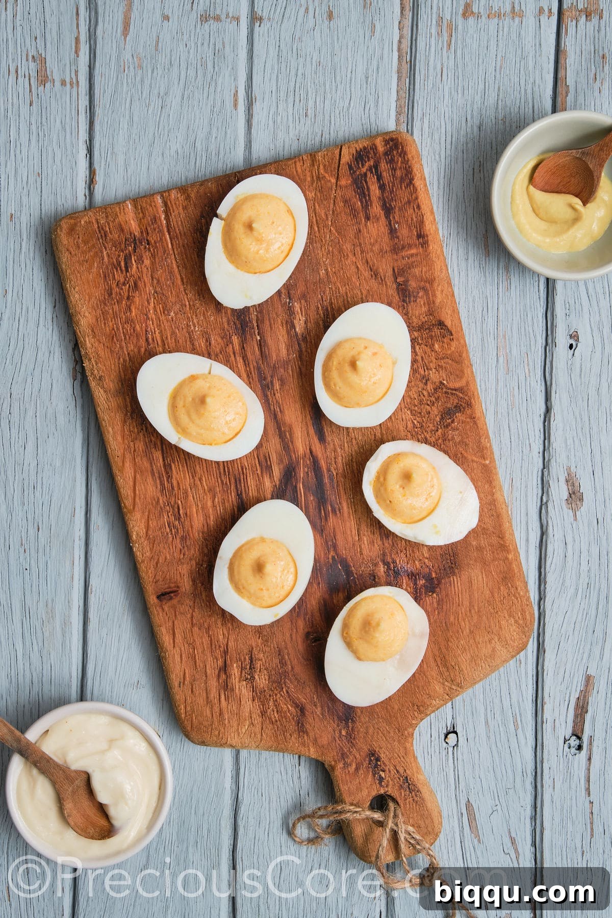A tray of egg white halves, expertly filled with the rich and creamy deviled egg yolk mixture.