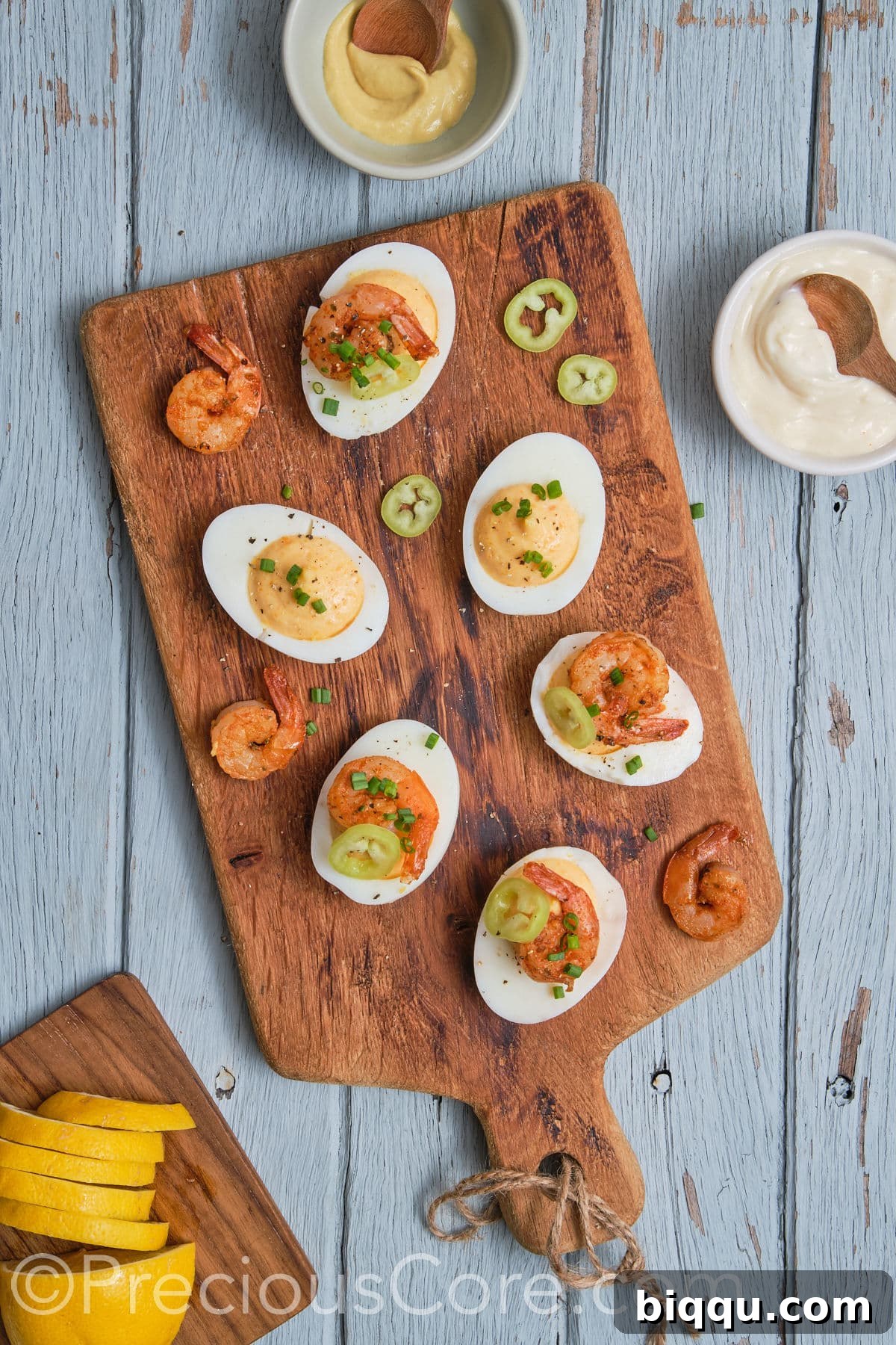The stunning final presentation of Deviled Eggs with Cajun Shrimp, garnished and ready to be served, arranged on an elegant platter.