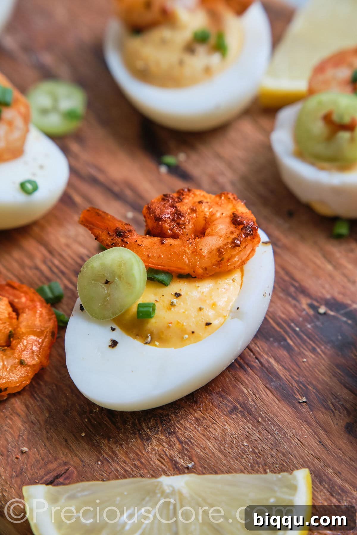 An enticing close-up of a single Deviled Egg with Cajun shrimp, perfectly garnished and ready to be savored, highlighting its intricate details.