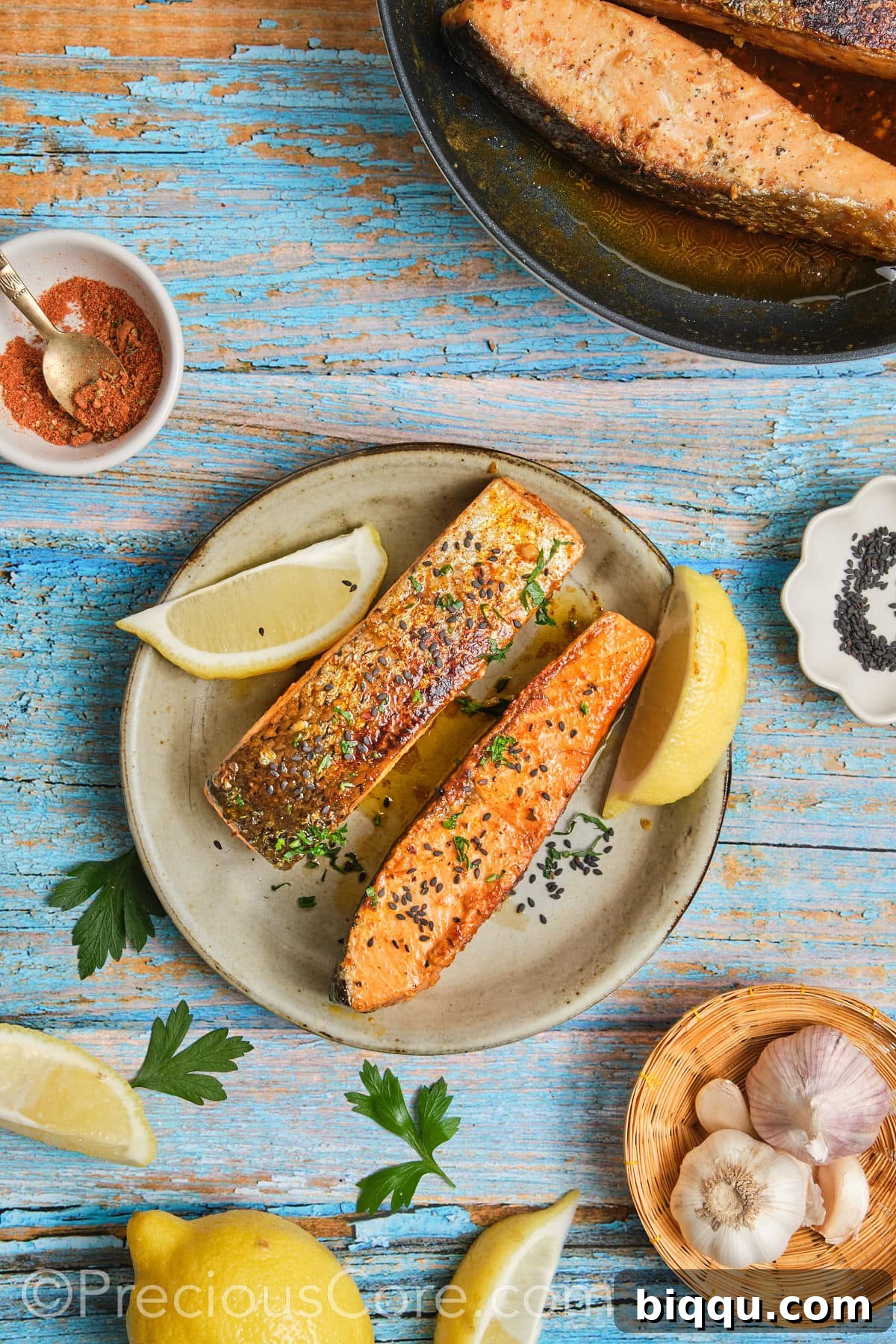 A vibrant close-up of garnished salmon, adorned with freshly chopped parsley and bright lemon wedges, ready to eat.