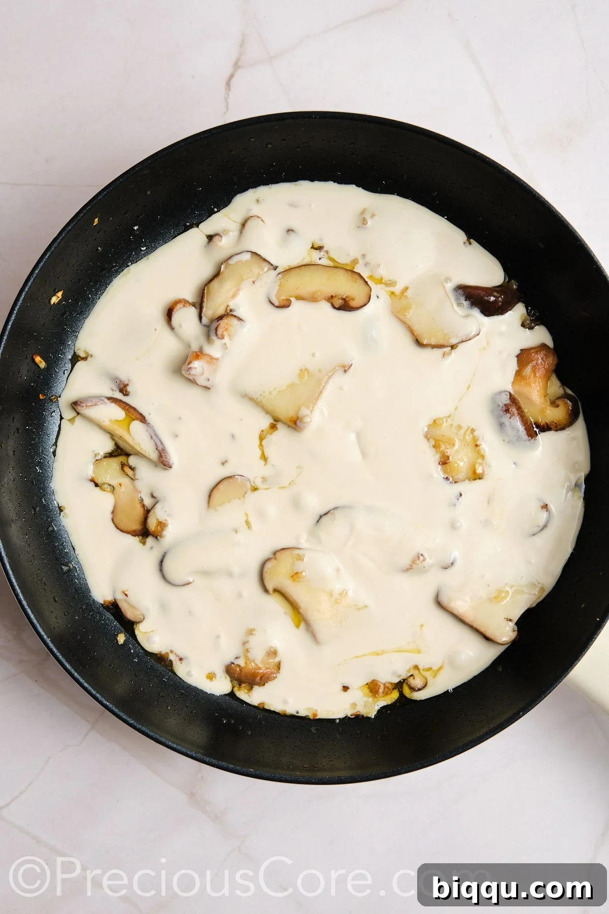 Creamy sauce added to mushrooms.