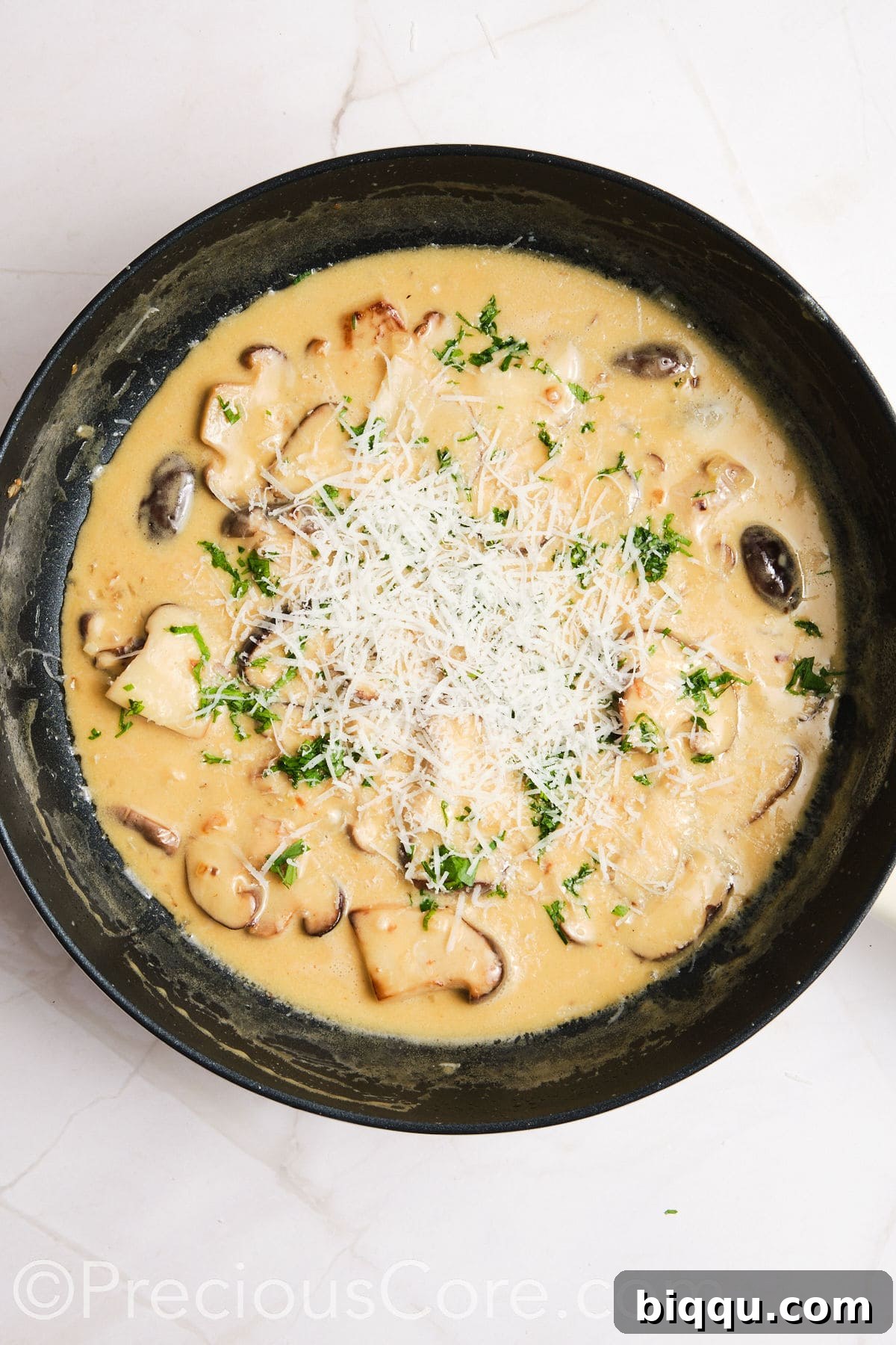 Parmesan added to creamy mushroom sauce.
