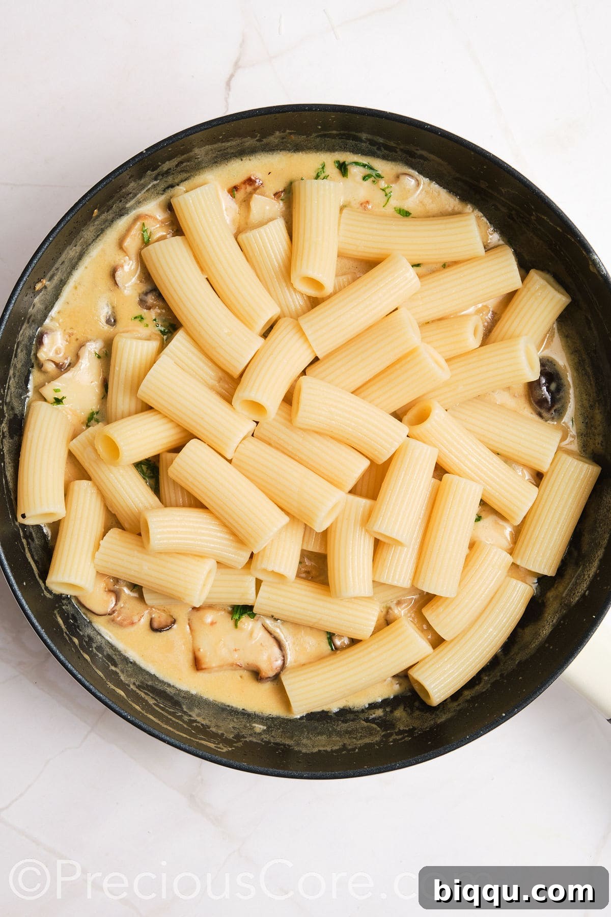 Cooked pasta added to sauce.