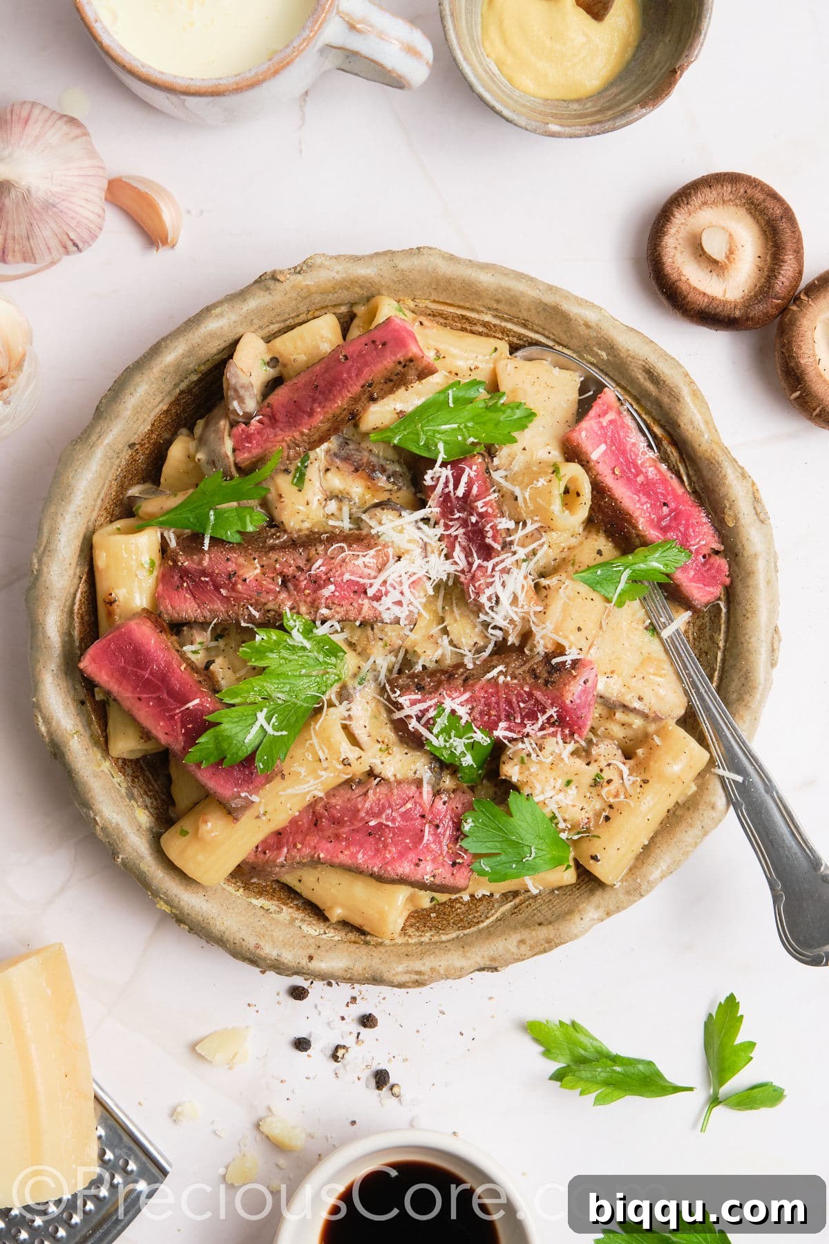 Pasta served topped with steak.