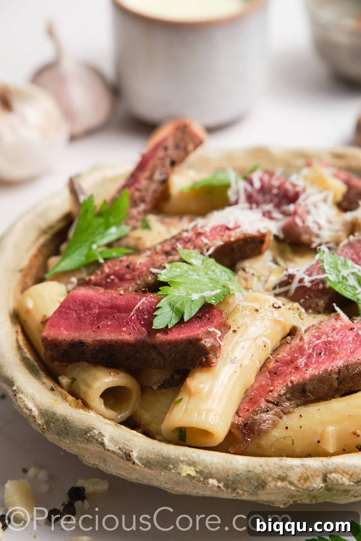 Close-up shot of steak and pasta.