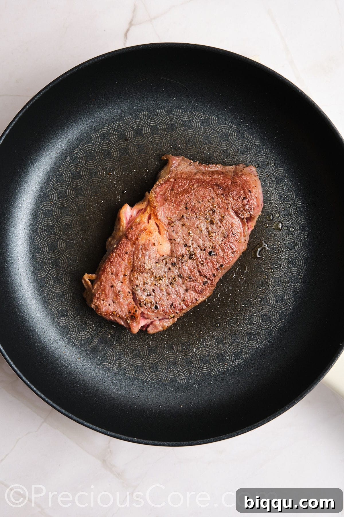 Steak cooked in a skillet.