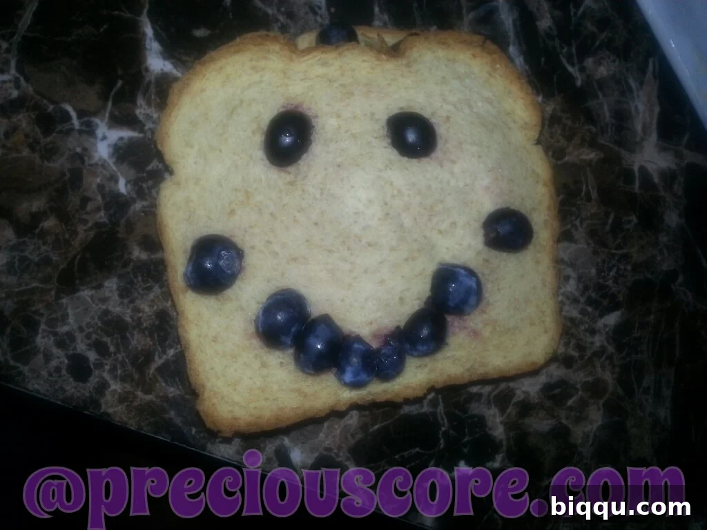 Creative food art: A face made with blueberries and bread slices