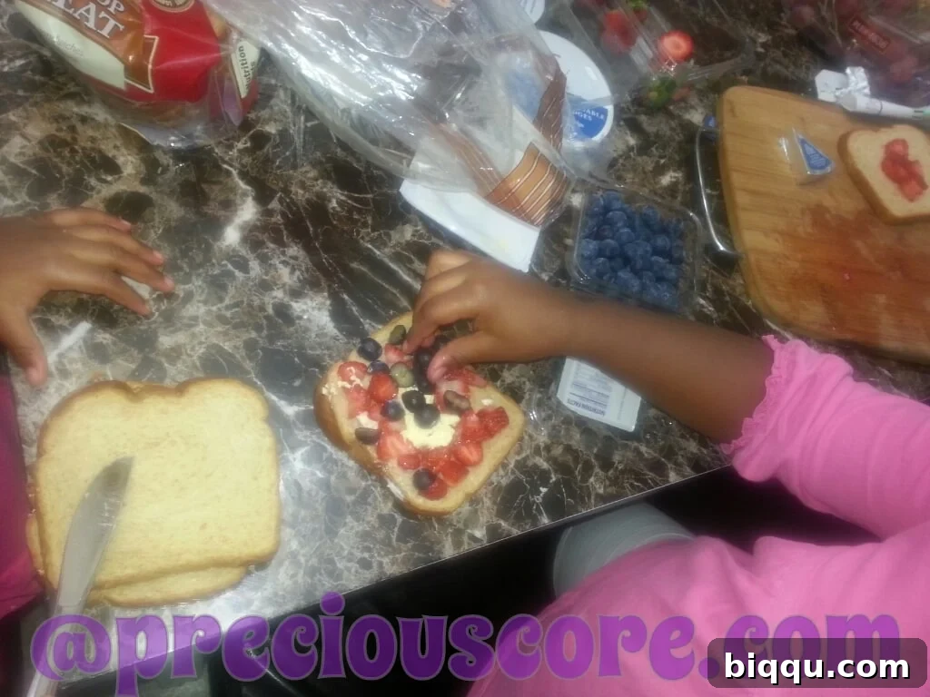 A colorful fruit sandwich prepared by a child for breakfast