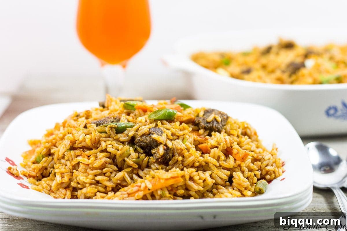 A perfectly prepared plate of Cameroonian Jollof Rice, showcasing vibrant colors and fluffy texture.
