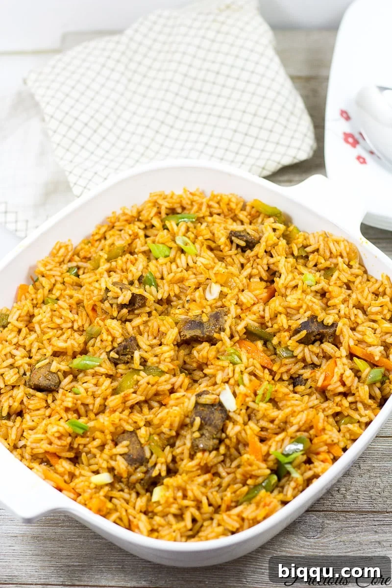A close-up of Jollof Rice served in a white bowl, highlighting its rich color and texture.