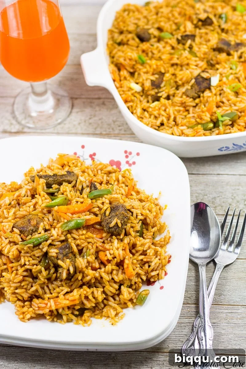 A serving of Cameroonian Jollof Rice garnished with fresh herbs, ready to be enjoyed.