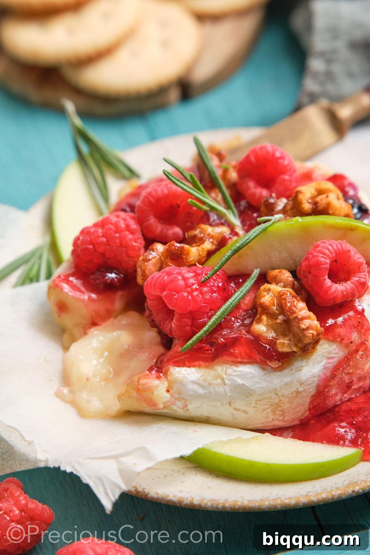 Served baked brie and preserves with melty cheese in the middle.